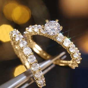 Macro shot of gold-plated wedding ring set with large center zircon and pave accents
