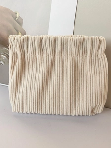 Minimalist beige corduroy cosmetic pouch with drawstring closure for daily organization