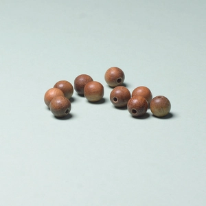 Macro shot of 10 brown Argentine green sandalwood round beads with holes for DIY jewelry