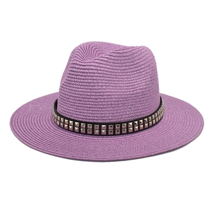 Detailed macro view of purple straw fedora with double-row metal rivet band