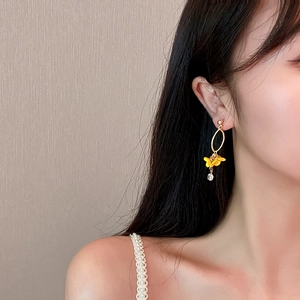 Elegant long drop earrings featuring yellow floral pendants and sparkling diamond accents