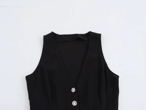 Detailed close-up of V-neck sleeveless jumpsuit with decorative metal buttons and soft fabric