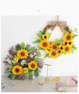 Detail showing two sunflower wreaths with bees and burlap bow for home wall decor