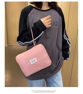 Pink nylon fitness pouch with handle strap shown in a lifestyle model setting
