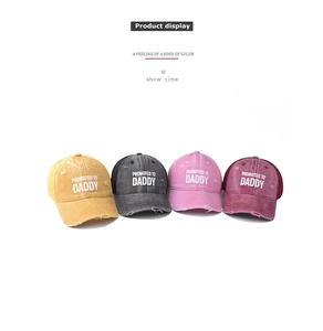Detailed view of four vintage cotton baseball caps with Promoted to Daddy print