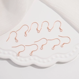 Detailed view of ten rose gold S925 sterling silver ear hooks for DIY jewelry making
