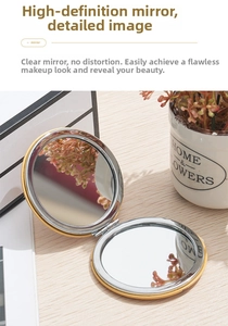 Close-up of golden foldable mini mirror with dual high-definition glass on wood base