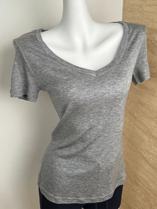 Close-up of gray tencel wool fabric texture on a V-neck slim fit short sleeve t-shirt