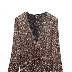 Chic bronze sequin dress with deep V-neck and padded shoulders in flat lay view