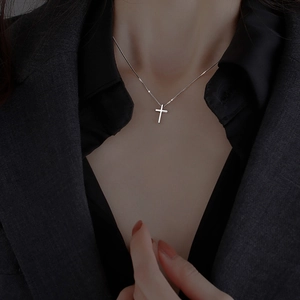 Minimalist silver cross pendant necklace with polished finish on a high-quality chain