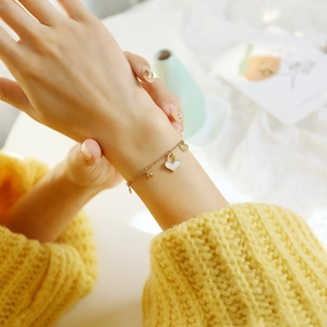Golden titanium steel bracelet with heart shell pendant and Love engraving for women
