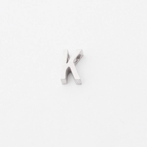 Macro detail of polished stainless steel K-letter pendant charm with 925 engraving