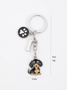 Detailed view of dachshund keychain with bone and paw charms showing 9cm total length