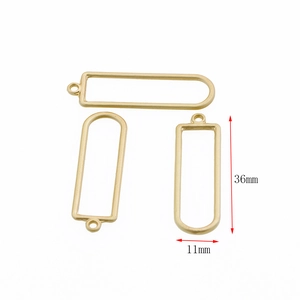 Detailed macro view of matte gold U-shaped DIY metal pendants with 36mm by 11mm dimensions