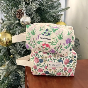 Quilted floral cosmetic bags with cotton fabric and ribbon handles for travel storage