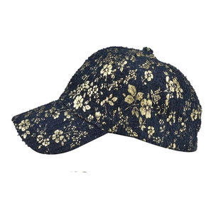 Detail view of cotton tweed baseball cap featuring vintage gold floral print patterns