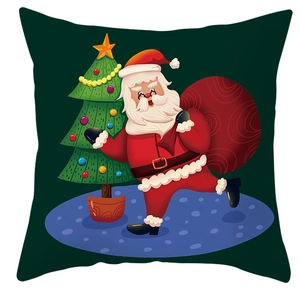 Close-up of cute Santa Claus and Christmas tree cartoon pattern on green cushion cover