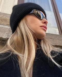 Close-up of minimalist black knit wool beanie showing detailed thermal texture and style