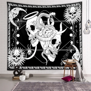 Detail of gothic tapestry featuring skeletons, snakes, and celestial symbols on white wall