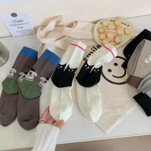Detailed knit of cotton mid-calf socks with cute cartoon animal patterns in warm settings