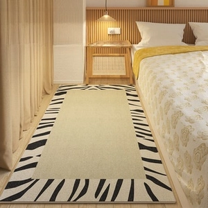 Detail of minimalist zebra pattern border on beige loop pile bedside carpet runner