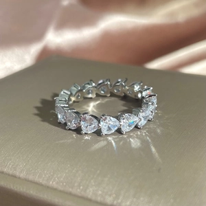 Detailed macro view of S925 sterling silver eternity ring with heart-shaped cubic zirconia