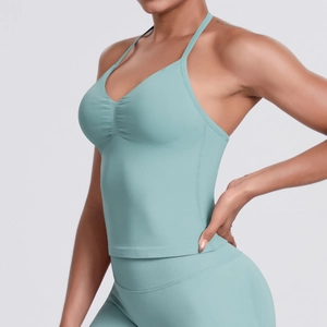 Close-up of seamless mint green sports bra with V-neck and ruched chest detail