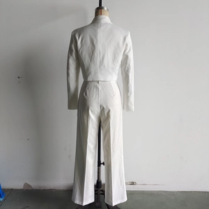 Rear view of white two-piece set featuring cropped blazer and high-waist wide-leg pants