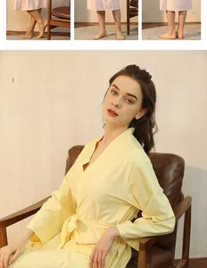 Detailed view of yellow waffle weave bathrobe texture with V-neck design and soft tie belt