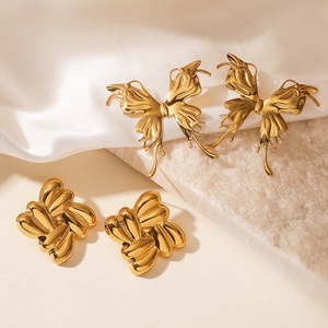 Chic gold butterfly and geometric flower stainless steel stud earrings set on marble