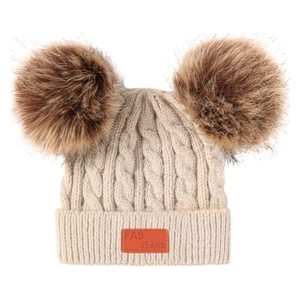 Winter knit baby beanie with double faux fur pom poms and warm cable knit texture