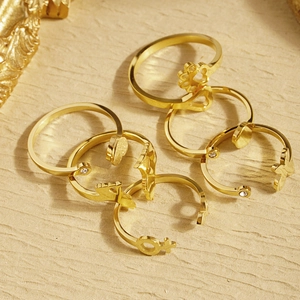 Detailed view of 5-piece gold stainless steel ring set with heart and star charms