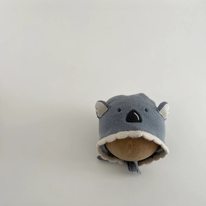 Detail of baby knitted koala hat with animal embroidery and warm cotton lining