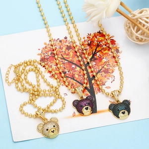 Detailed display of cute bear necklaces with colorful zircons and golden bead chains
