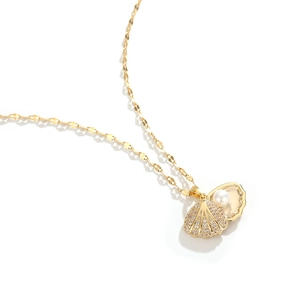 Elegant gold shell pendant necklace with white pearls and sparkling cubic zirconia stones