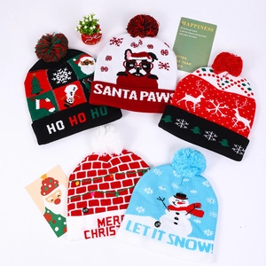Colorful LED Christmas beanies with festive patterns like Santa and reindeer on white background
