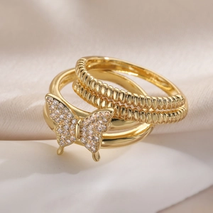 Detail of gold-plated butterfly ring set with cubic zirconia on silk fabric