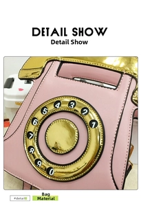 Detail of pink retro telephone purse showing mock dial and gold mirror finish trim