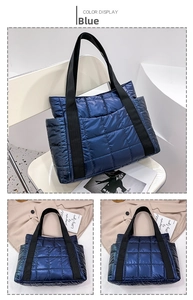 Detail view of blue metallic quilted tote bag with side pocket and woven handles