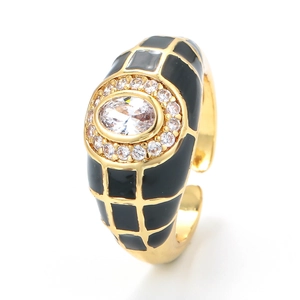 Adjustable gold open ring with black enamel grid and oval zircon center on white background
