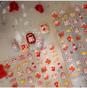Detail of 2026 Lunar New Year nail stickers featuring lucky cats and red envelopes