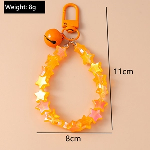 Detail of yellow star beaded keychain with bell and lobster clasp, 11cm length