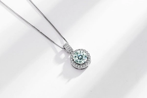 Macro shot of geometric Moissanite pendant with halo diamonds and a silver chain
