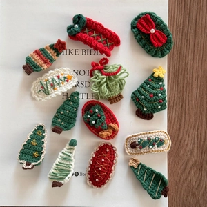 Detailed view of 12 festive crochet Christmas hair clips on an open book background