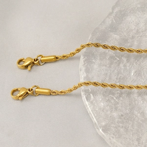 Close-up of gold stainless steel twisted rope chains with secure lobster claw clasps