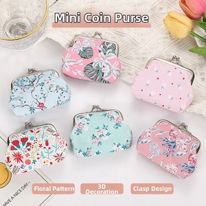 Detail of floral kiss-lock coin purses with vintage metal clasp and thick canvas fabric