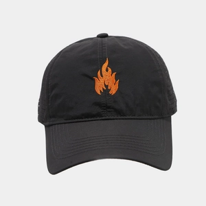 Detail of laser-cut ventilation holes and orange flame embroidery on black baseball cap