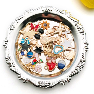 Assorted DIY alloy oil drop pendants with heart and star shapes on a silver tray