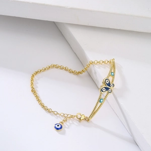 Böhmisches 18K vergoldetes Kettenarmband mit blauem Emaille-Schmetterling und bösem Blick
