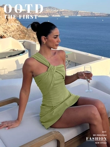 Detail showing the olive green one-shoulder dress with side ruching and slim-fit cut